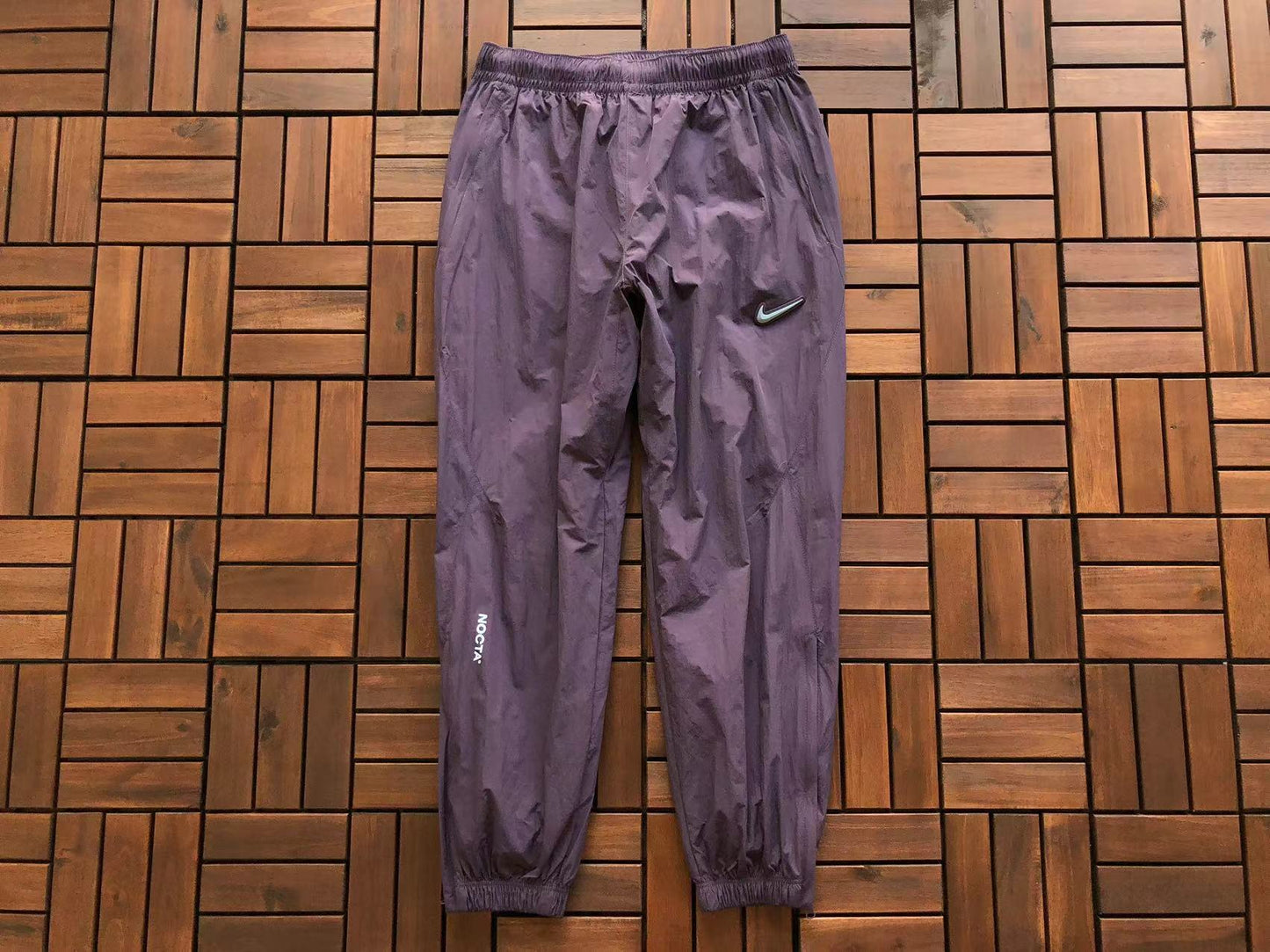 Calça Nike x NOCTA Woven Track Dark Raisin